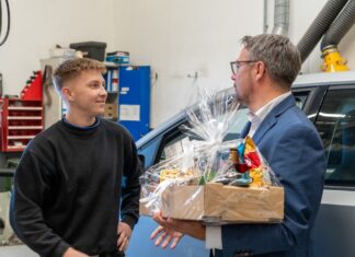 21-årige Marcus Bugge Raasdal Jensen fra Assens hædres af borgmester Jesper Skov Mikkelsen hos Therkildsen Biler i Hobro. Foto: Mariagerfjord Kommune.